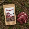 Flat-lay Divočák jerky 176168 – sáček + syrové maso z divočáka na lesním jehličí.